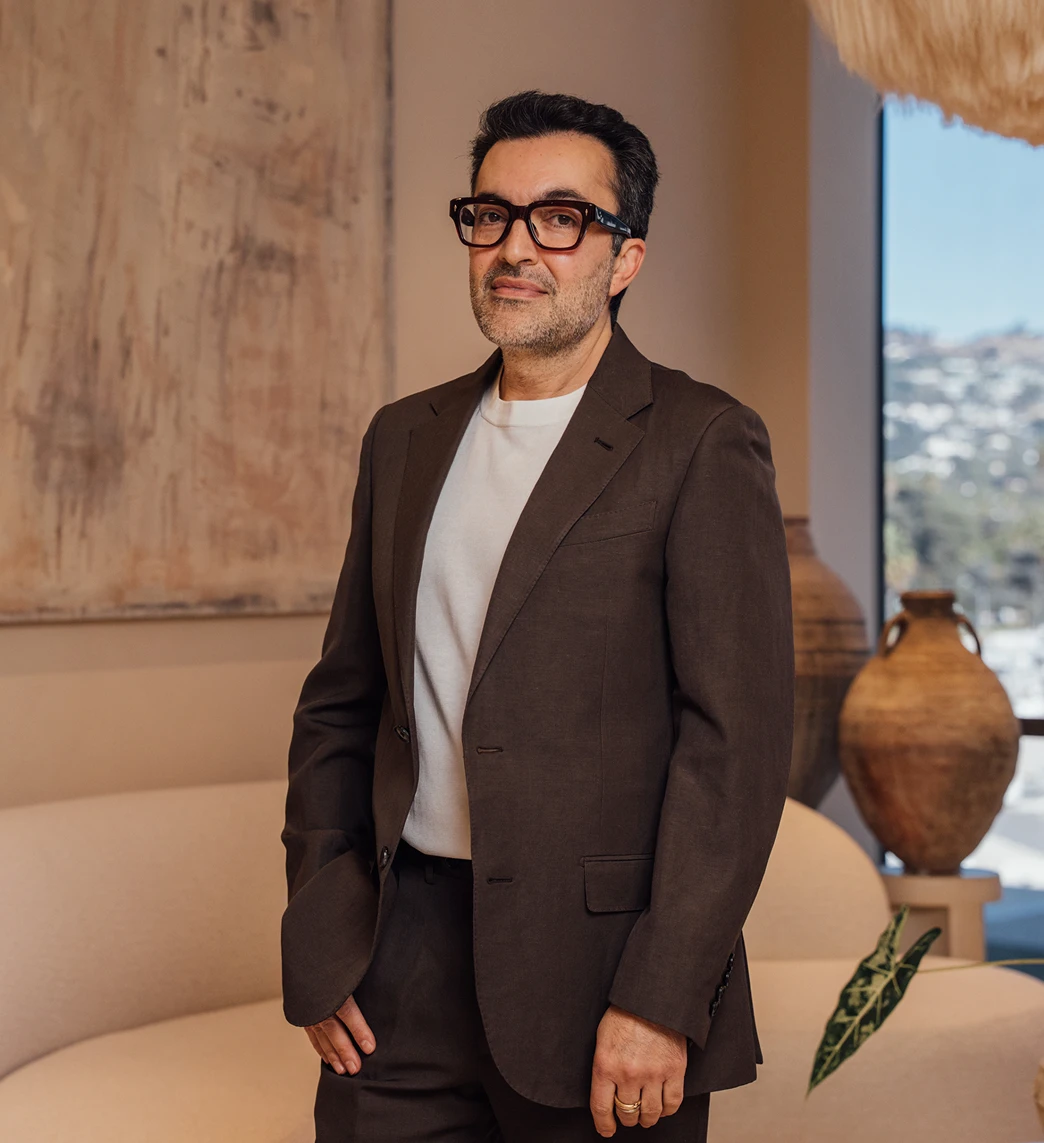 Dr. Moradzadeh wearing a brown suit and white shirt, portrait posed.