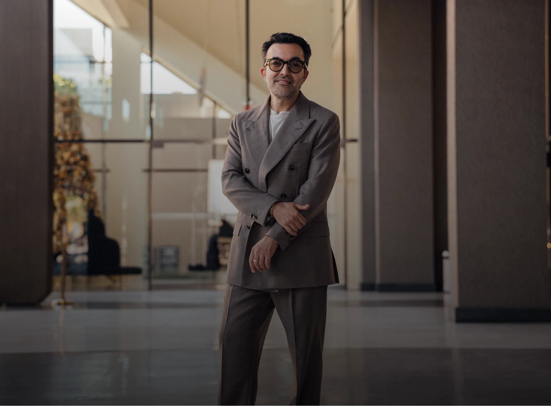 Dr. Moradzadeh wearing a brown suit and white shirt, portrait posed